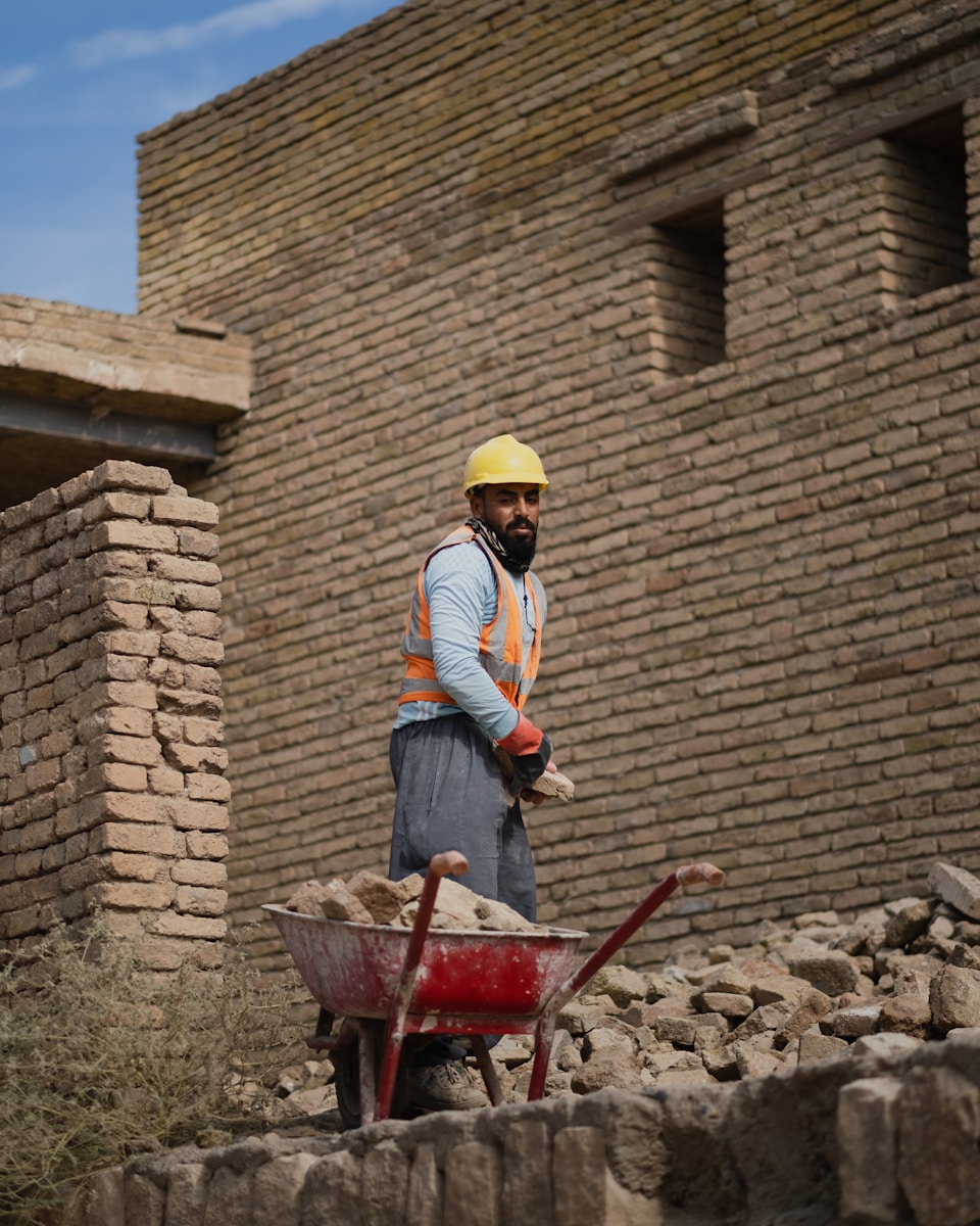 a man standing next to a pile of rubble